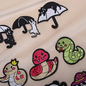 Cute cartoon embroidery patches featuring black cats and snakes for clothing repair and decor.