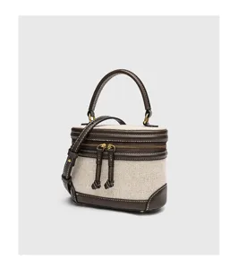 Vintage Canvas Kosmetiktasche mit braunem Lederbesatz, Tragegriff und Schultergurt.