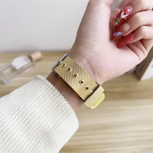 Detailed view of the stylish gold metal mesh smart watch strap worn on wrist, premium finish.