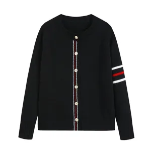 Women's black knit cardigan featuring a round neckline, pearl buttons, and stylish red white stripes.