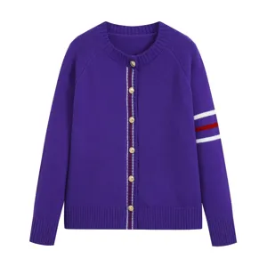 Close-up detail of purple knit cardigan featuring gold tone buttons and striped sleeve trim.