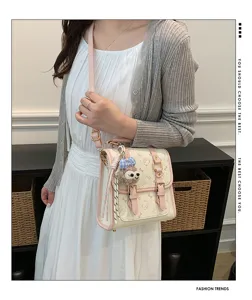 Chic college style PU leather crossbody shoulder bag with cute cartoon prints and plush charm.