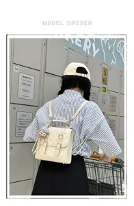 Women cute small leather backpack retro commuter school bag with cute charm and bow prints.
