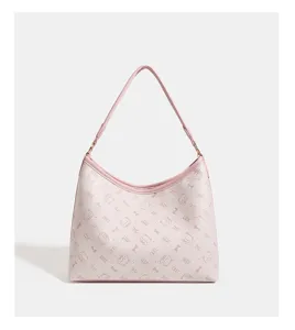 Pink shoulder bag detail showing cute cat pattern and stylish bow print leather texture.