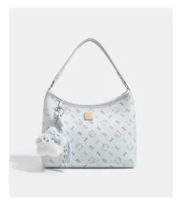 Detailed view of the stylish white hobo shoulder bag featuring cat print and plush charm.