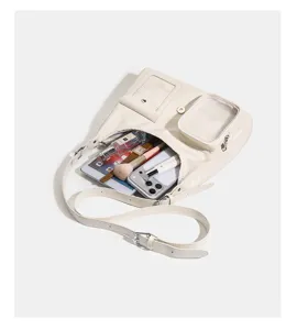 Detailed view of the beige ita bag showing interior capacity and transparent card pocket display.