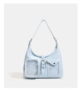 Detail view of the light blue shoulder bag with transparent pocket and buckle decoration.