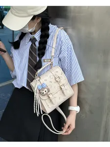 Vintage small backpack retro commuter bag with cute plush pendant and double buckle detail