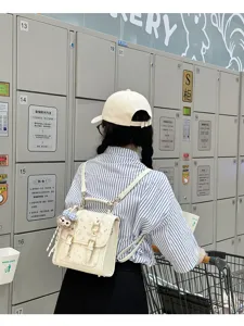 White retro style women backpack with cute print and double buckle straps for daily commute.