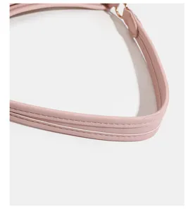 Pink leather handbag strap detail showing fine stitching and smooth finish craftsmanship.