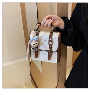 College style women handbag with cute cartoon print and plush pendant, chic commuter shoulder bag.