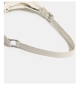 White PU leather shoulder bag detail shot featuring metal buckles and neat stitching.