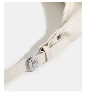 Close up detail of white leather shoulder bag strap buckle and fine stitching accessories