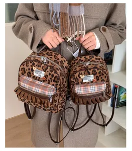Leopard print plush mini backpack detail showcasing retro plaid front pocket and cute ruffles.