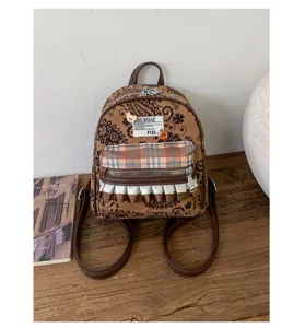 Retro vintage mini backpack with paisley pattern, plaid pocket and cute ruffle detail.