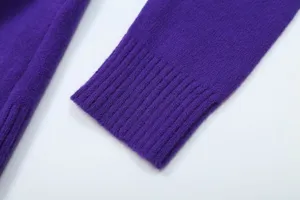 Detailed close-up shot of the purple knitted sweater cuff, showcasing fine ribbed texture.
