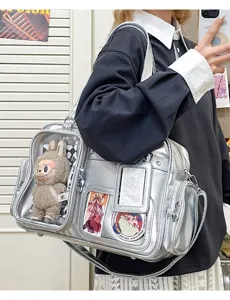 Details of the silver ita bag showing transparent front window, large capacity, and doll display.