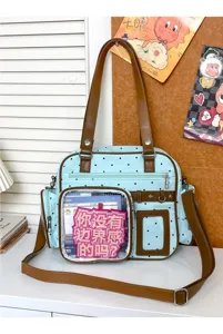 Mint green polka dot ita bag detail showing transparent front display pocket and brown straps.