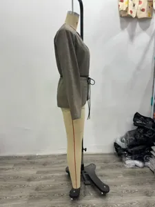 Plaid blazer detail view showing slim fit, V-neck, and belted waist design on mannequin.