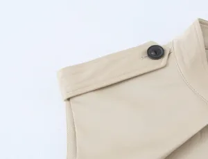 Beige women's dress shoulder detail with epaulet and black button fashion apparel.