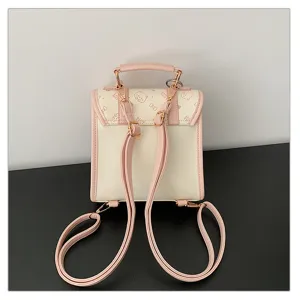 Detail view of cute college style pink backpack flap featuring sweet print and straps.