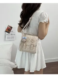 Chic retro women's mini backpack with cute kitty print, metal buckles, and plush charm.