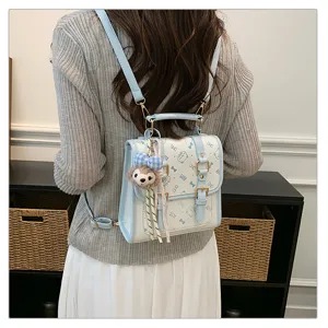 Collegiate women backpack, PU leather casual daily commuter school bag with cute print charm.