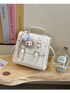 Chic white PU leather mini backpack for women, featuring cute plush charm and dual buckle design.