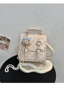 Vintage beige mini backpack with cute cat print, pearls, and plush pendant for daily commute.
