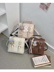 Chic vintage PU leather mini backpack for women, cute bear pendant, stylish casual daily bag.