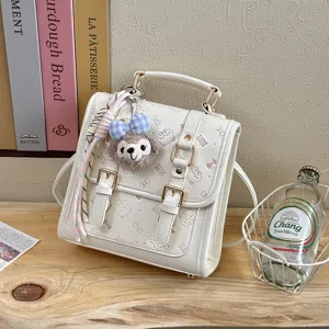 White faux leather vintage mini backpack with cute plush animal charm and bow embossed details.