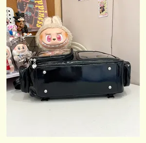 Clear window detail of black ita bag with metal feet, perfect for anime pins and daily commute.