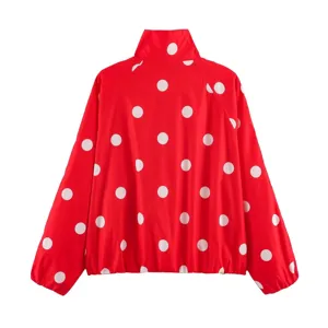 Red and white polka dot jacket detail, featuring high collar and elastic hem, stylish outerwear.