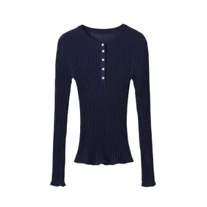 Detailed view of women's dark blue ribbed knit top featuring long sleeves and button crew neck.
