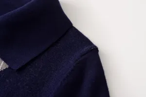 Vista detallada del cuello del jersey polo de punto azul oscuro para mujer, casual.