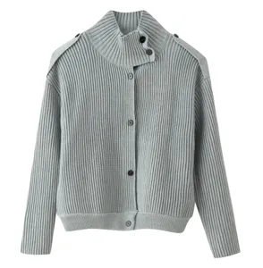 Close-up detail of grey ribbed knitted cardigan with high collar and front buttons for women.