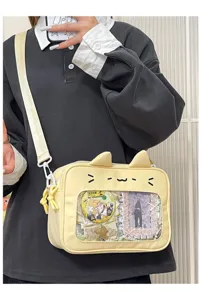 Close-up of the cute yellow cat ita bag with transparent window, perfect for anime fans.
