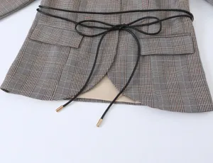 Plaid blazer detail shot showing waist tie belt and premium fabric texture for women.