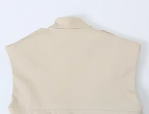 Back detail of a chic beige sleeveless dress, featuring a stand collar and clean tailoring.