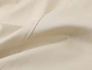 Khaki twill fabric close up detail showing fine texture and neat stitching craftsmanship.