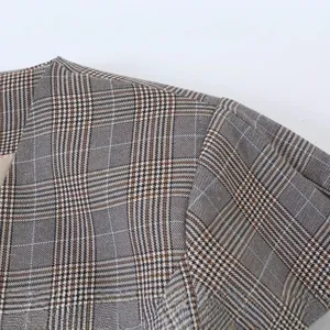 Women's vintage plaid blazer jacket shoulder detail, casual elegant outerwear piece.