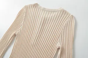 Close-up detail of the ribbed knit texture, featuring long sleeves and a classic crew neckline.