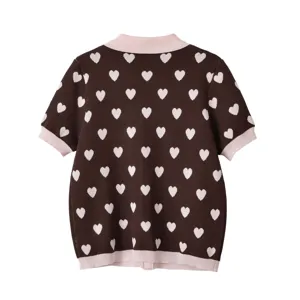 Détail haut tricot jacquard cœurs marron, pull manches courtes avec bordures roses contrastées.