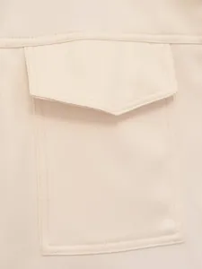 Detailed view of women casual vest pocket, beige solid color, stylish pocket flap design.