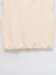Detail view of casual sleeveless beige vest zipper hem women fashion basic solid apparel