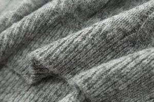 Grey ribbed knit sweater fabric detail showing soft texture and cozy winter apparel material.