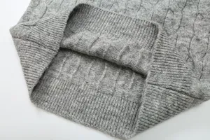 Close-up detail of grey cable knit sweater women casual ribbed hem texture apparel fashion