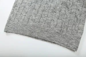 Grey cable knit sweater detail shot showing fine texture and ribbed hem close-up apparel