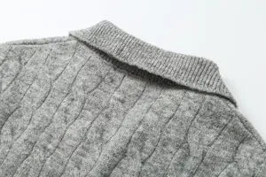 Close-up detail of women's gray knitted sweater featuring a classic lapel and ribbed texture.