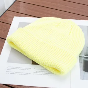 Detailed view of solid color knitted beanie hat, soft warm winter wool cap for men and women stylish.